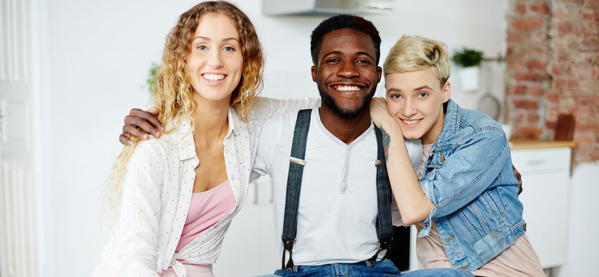 A black man and two girls are smiling.