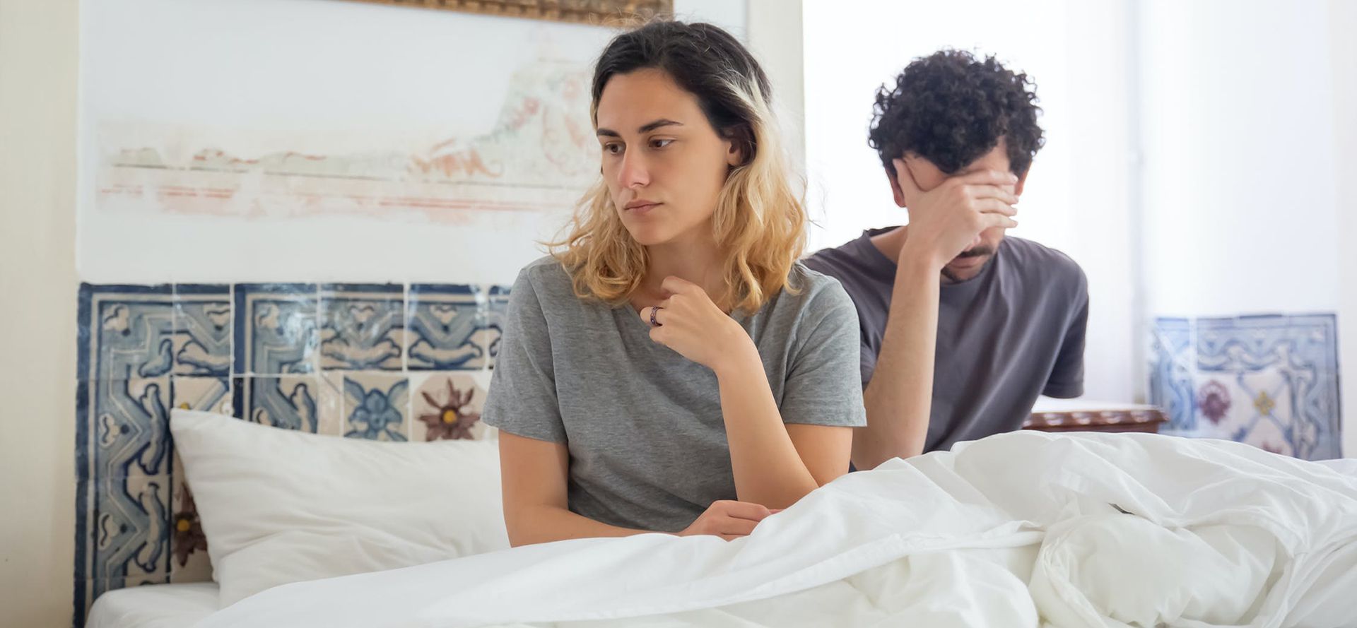 Woman break up with man on the bed.
