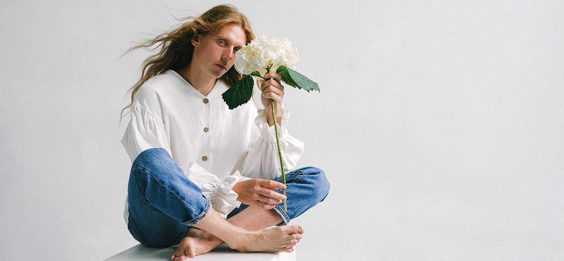 Androgynous with a flower.