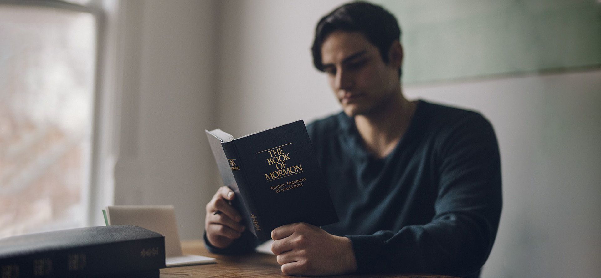 Man reading the book of mormon.