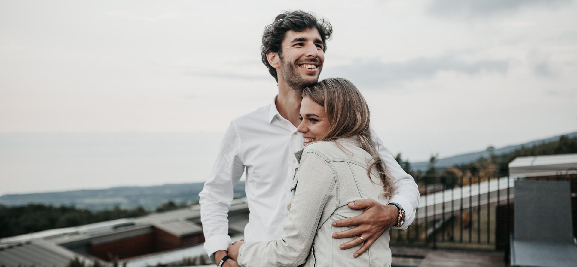 A man hugging a woman.