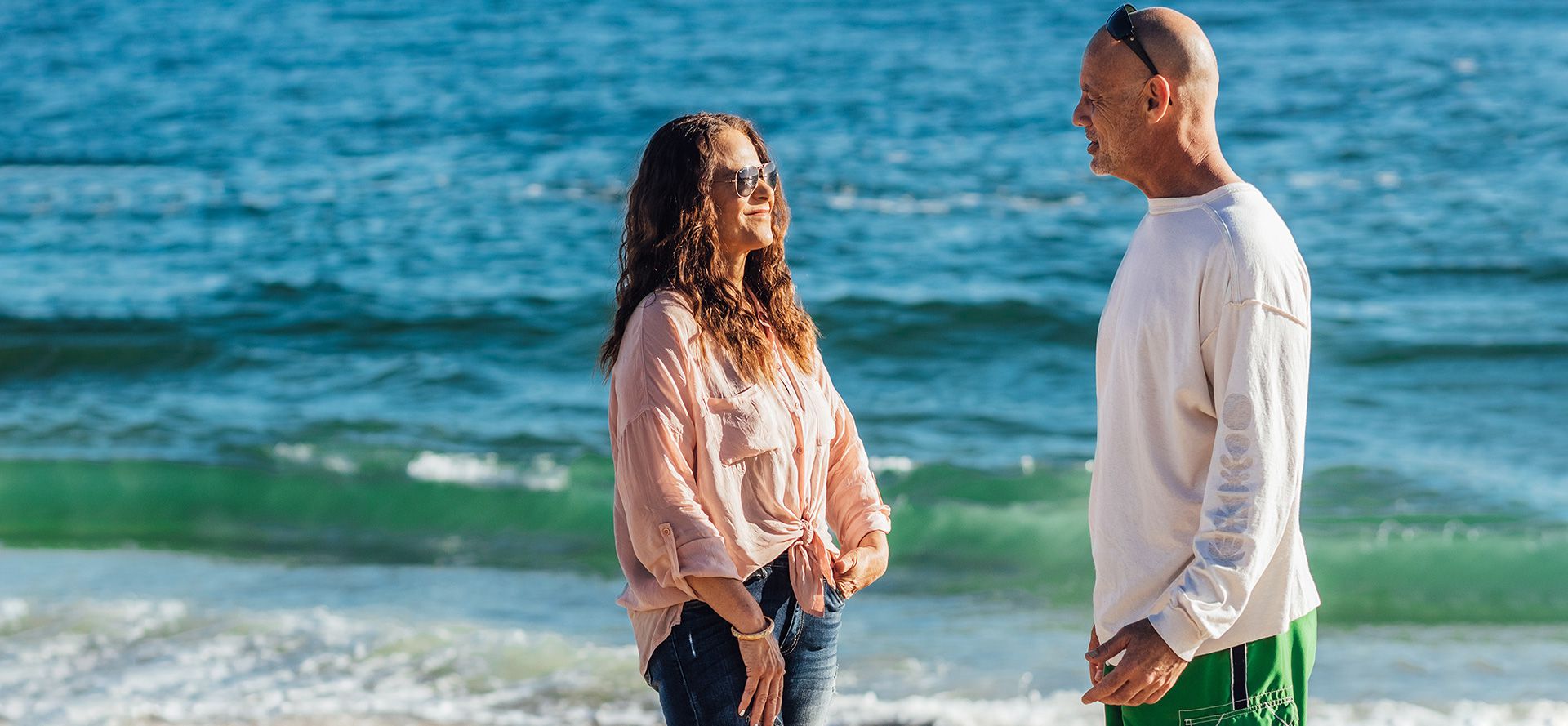 Younger woman with older man on the beach.