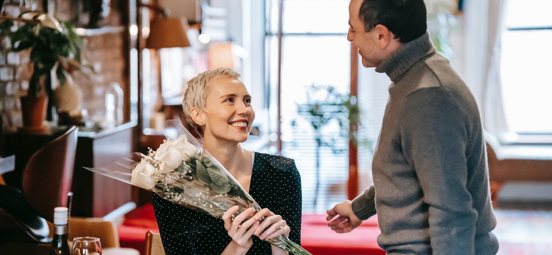 The man handed the woman a bouquet of flowers.