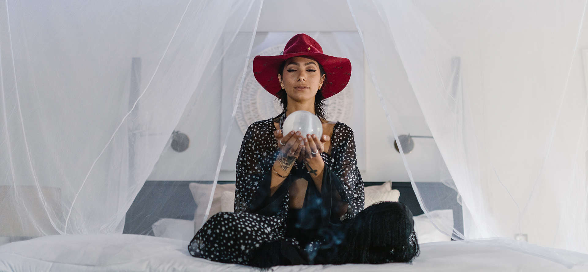 The astrologer is meditating on the bed.