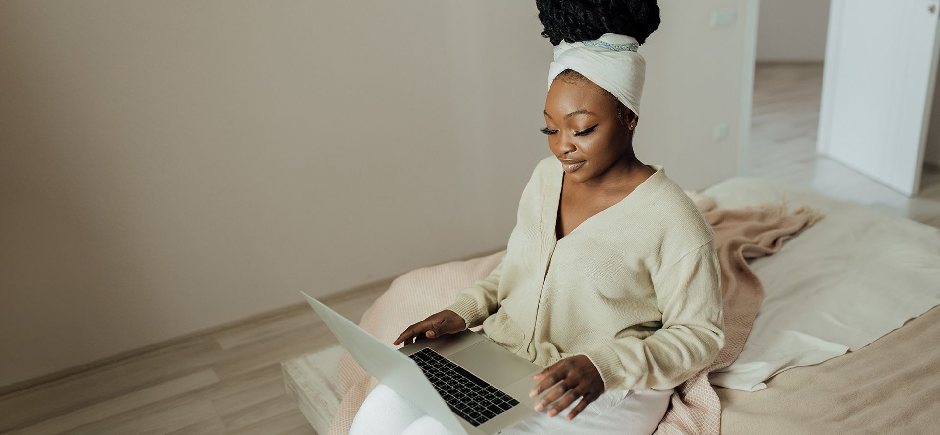 Woman sitting at home with notebook.