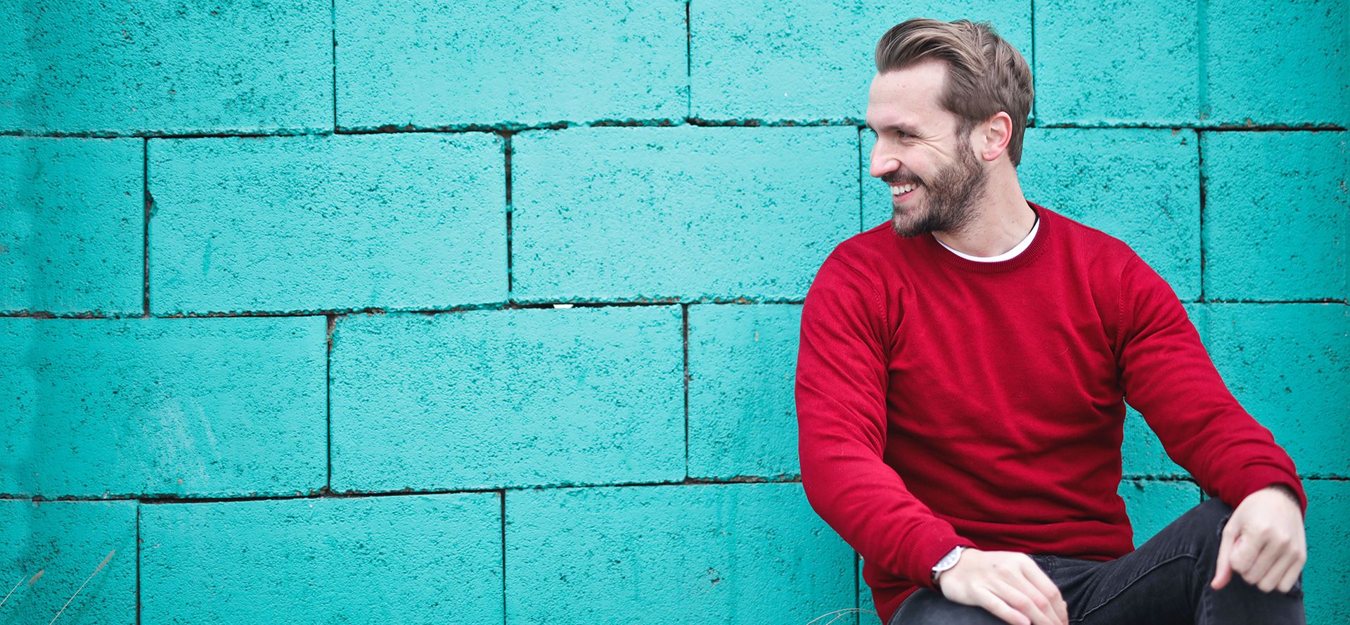 Man near the blue wall.