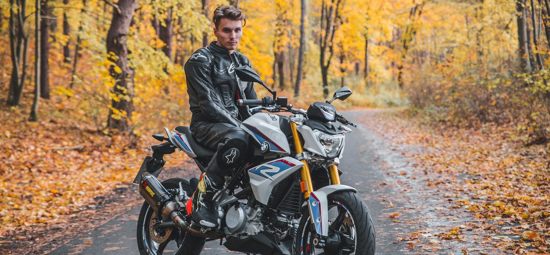 Single biker on a motorcycle against the background of the autumn forest.