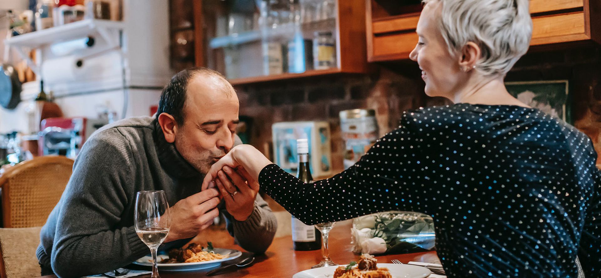 A man kisses a woman'