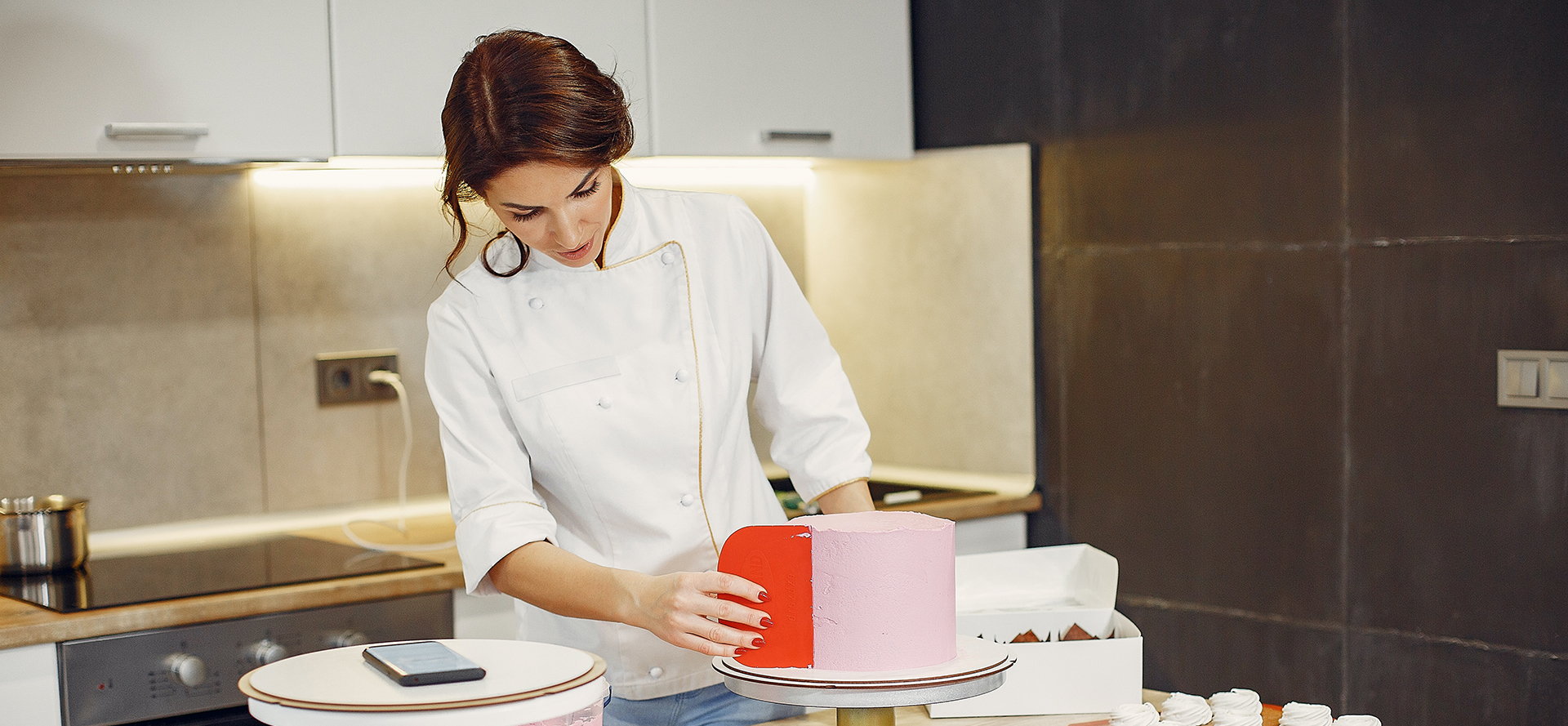 The chef decorates the cake.