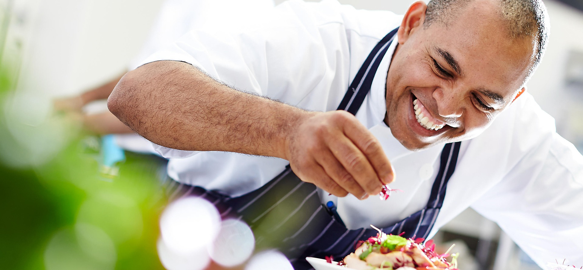 The chef decorates the dish.