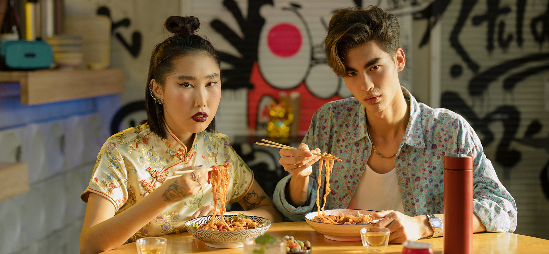 A Chinese couple on a date eating noodles.