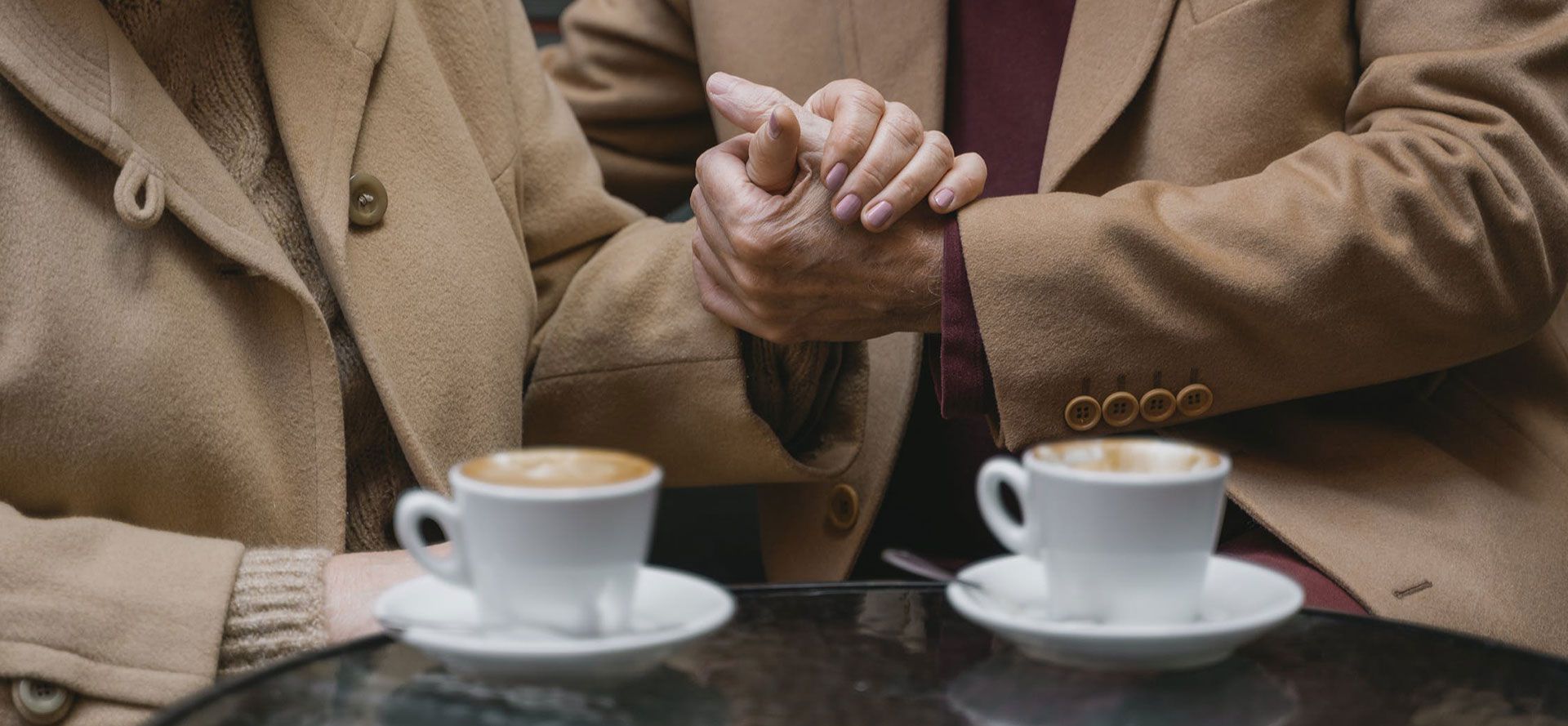 An old couple holding hands.