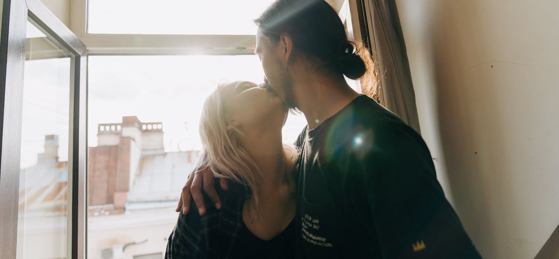 Young people kissing at home.