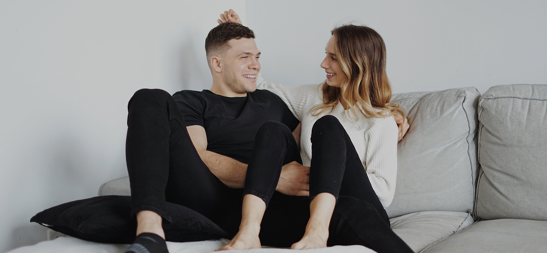 Romantic Polish couple hugging on the couch.