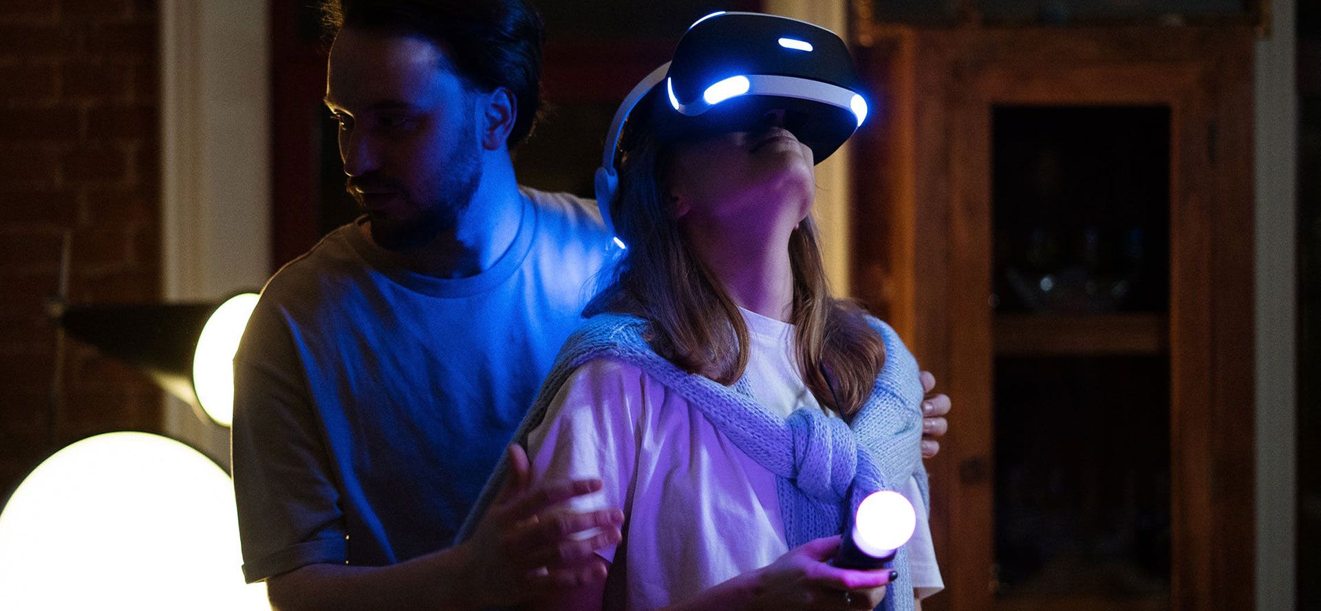 The girl in a VR headset is playing a game.
