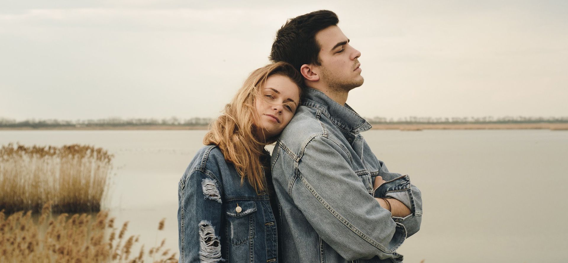 Woman put her head on the male shoulder.