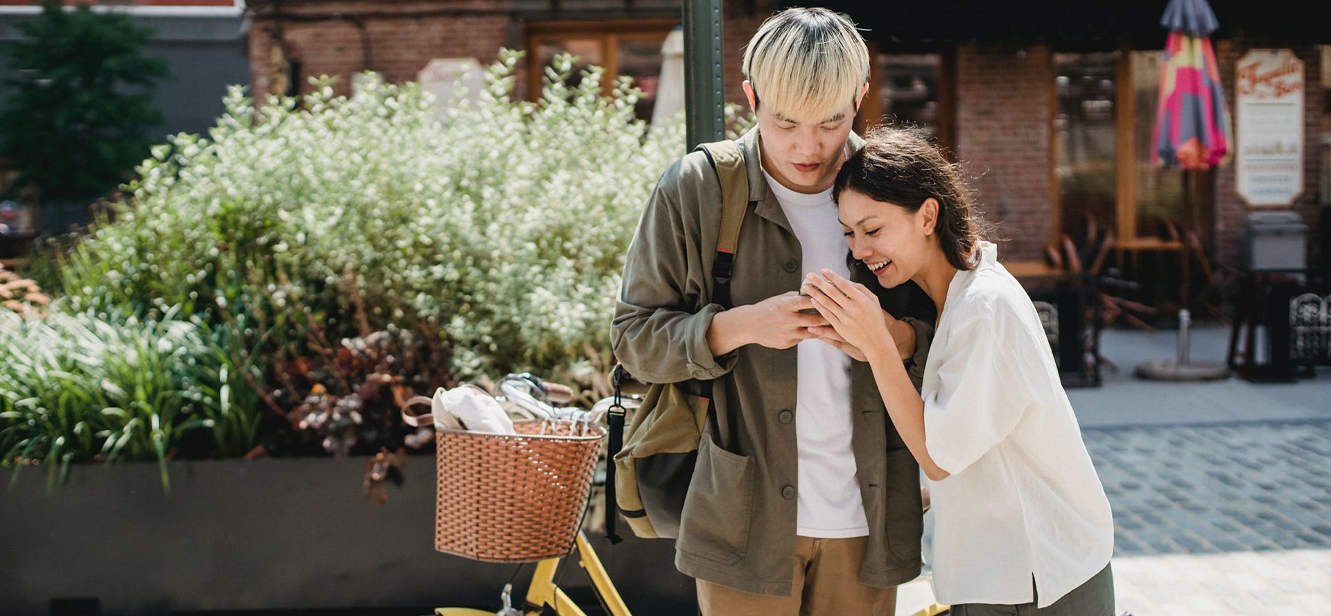 A couple watches a video in the phone.