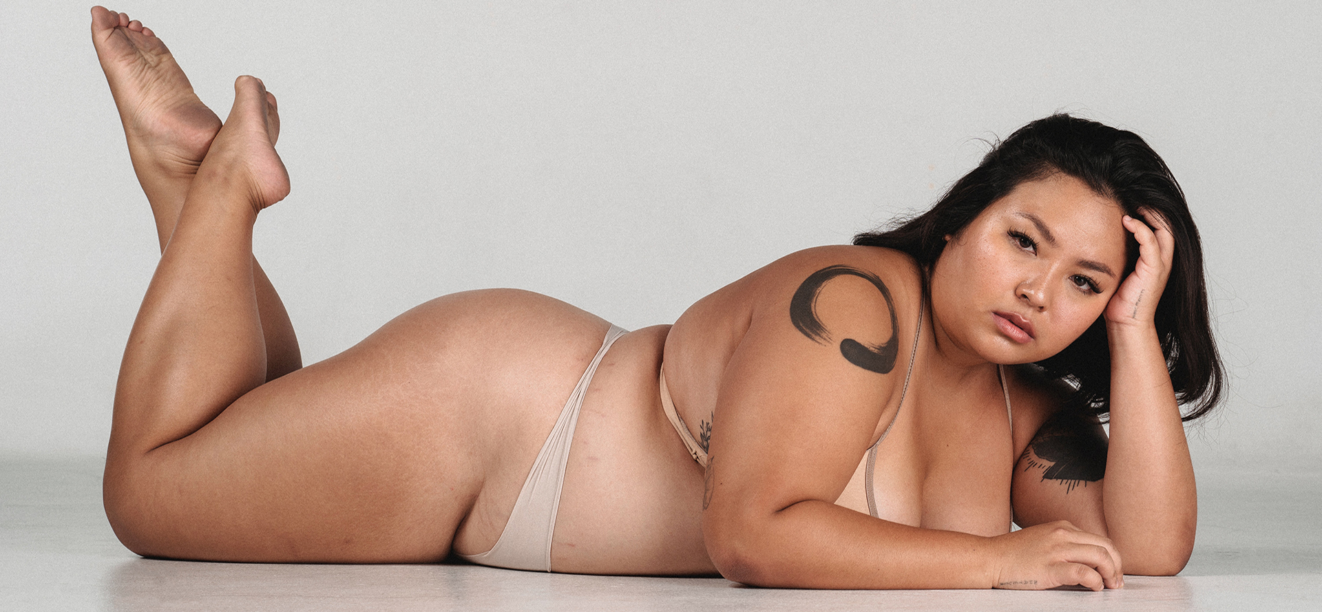 A beautiful overweight woman lies in lingerie.