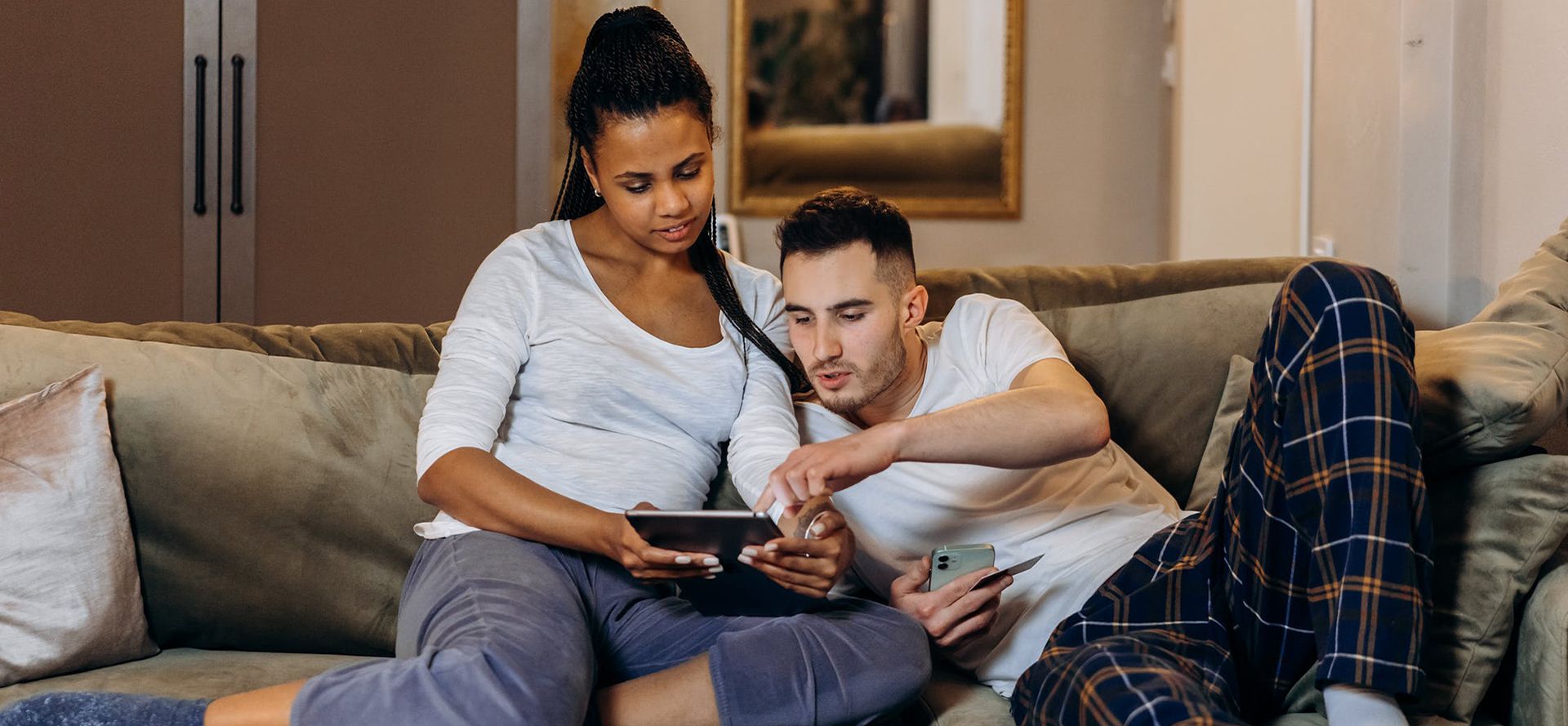 The couple is relaxing on the couch.