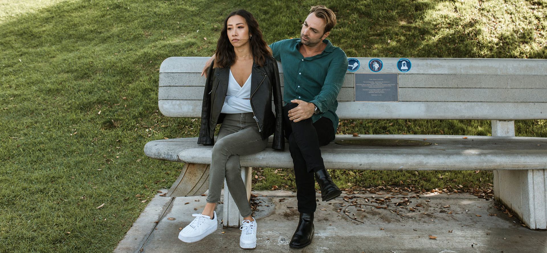 A couple is sitting on the bench after a quarrel.