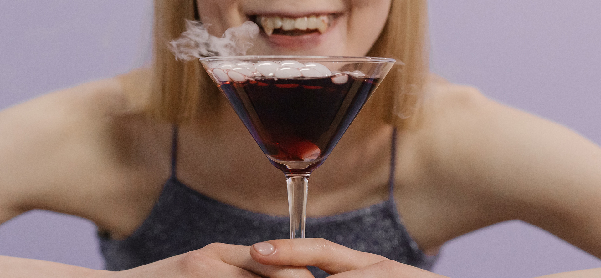 Vampire girl with a bloody cocktail.