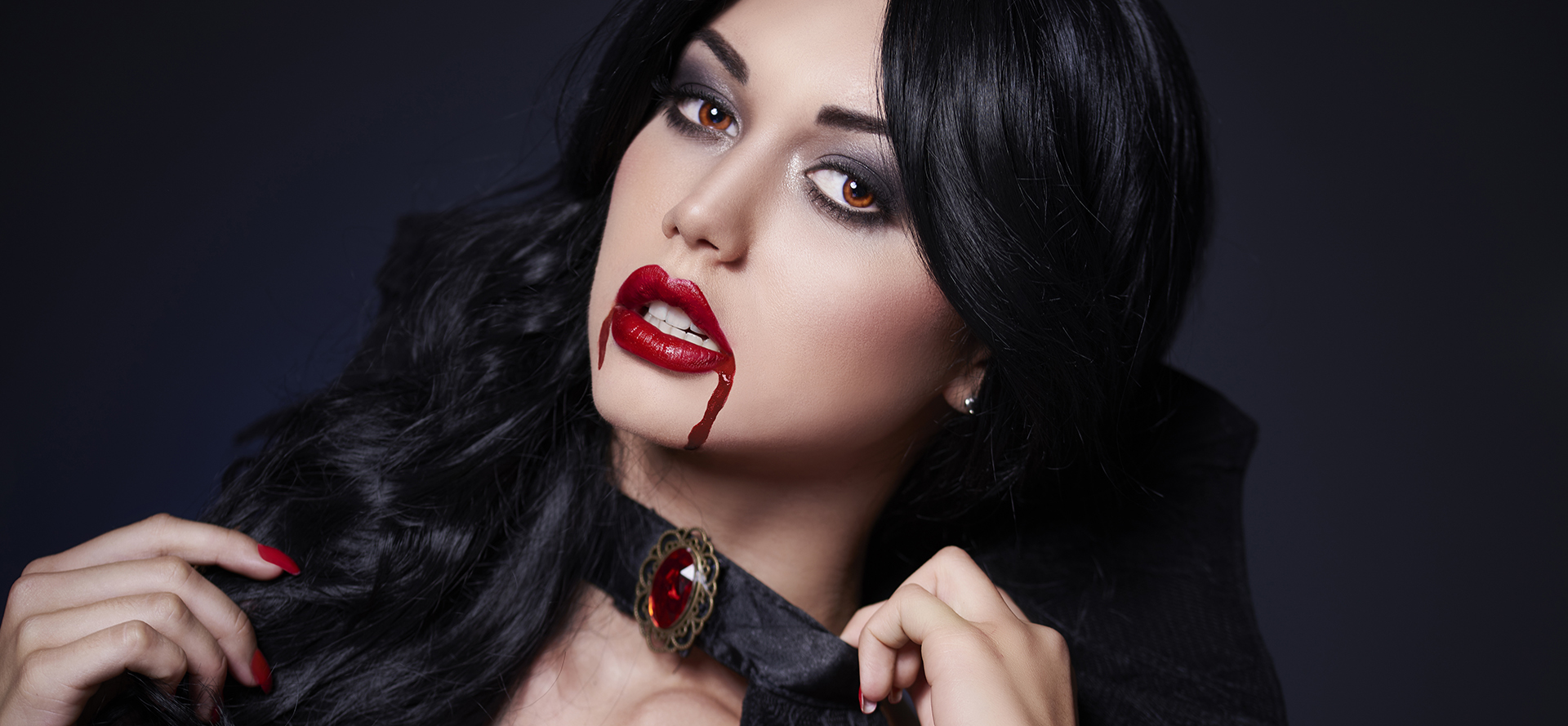 Dark hair vampire with blood on the face.