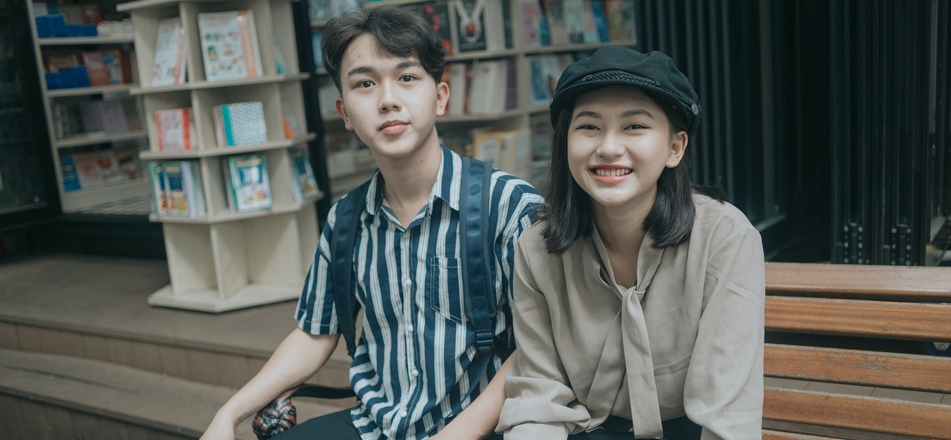 Vietnamese couple sitting on a bench.