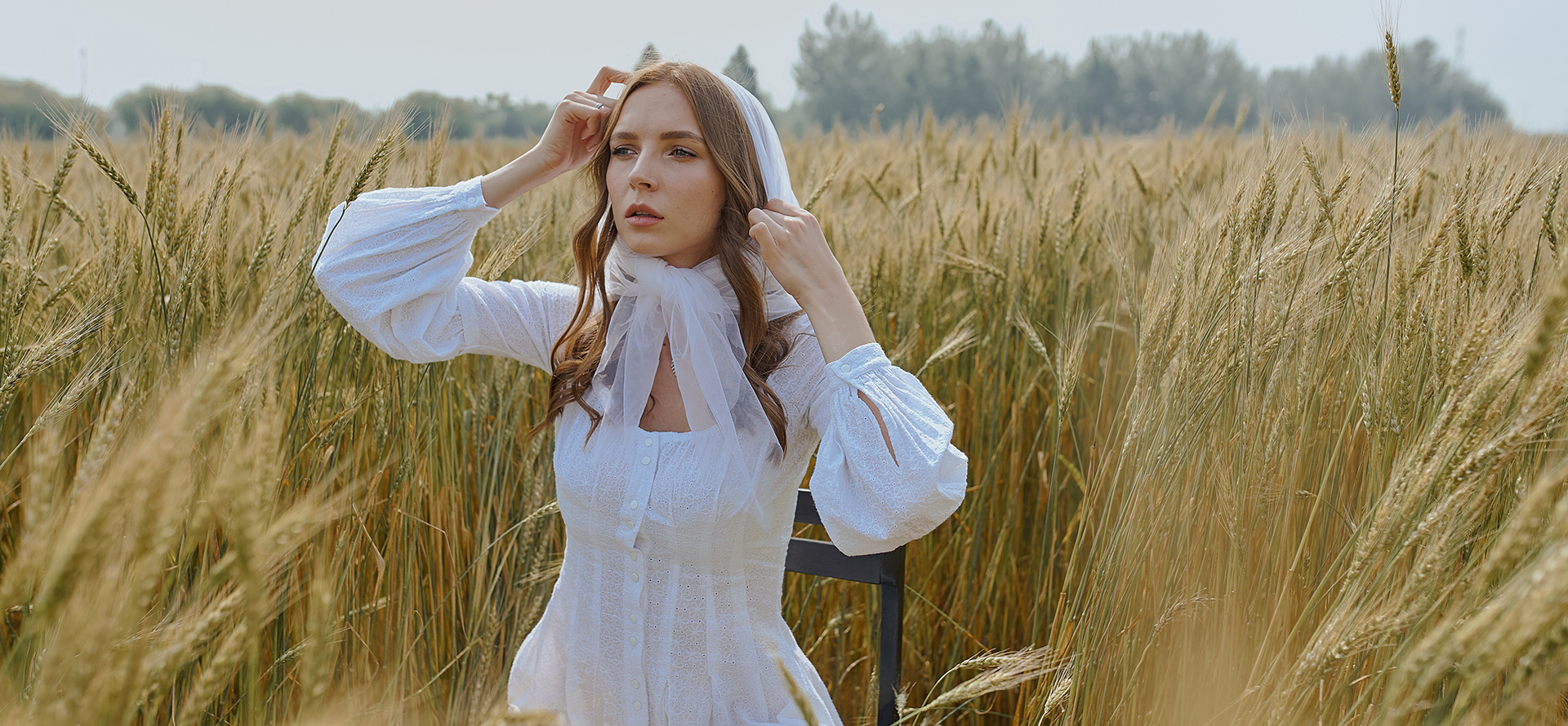 A virgin girl in a white dress in the field.