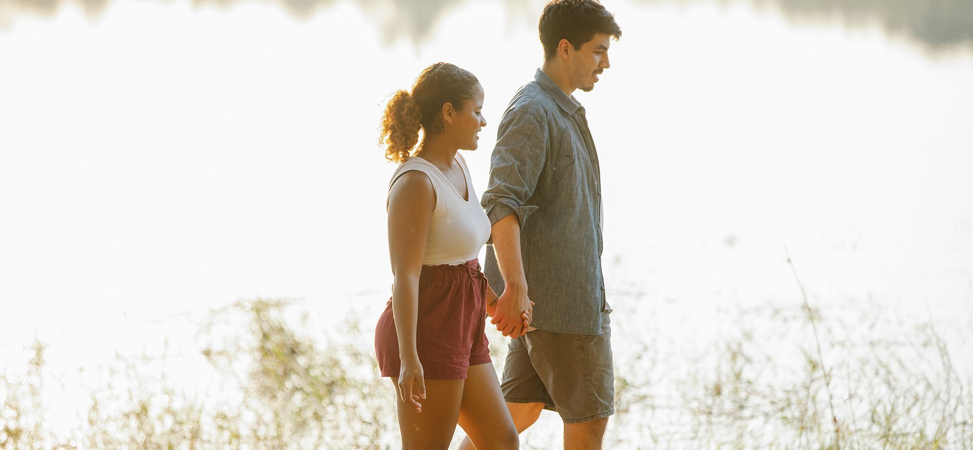 People with casual relationships walk near the river.