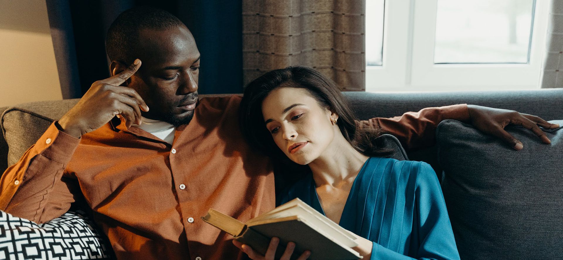 Widower reading book with woman.
