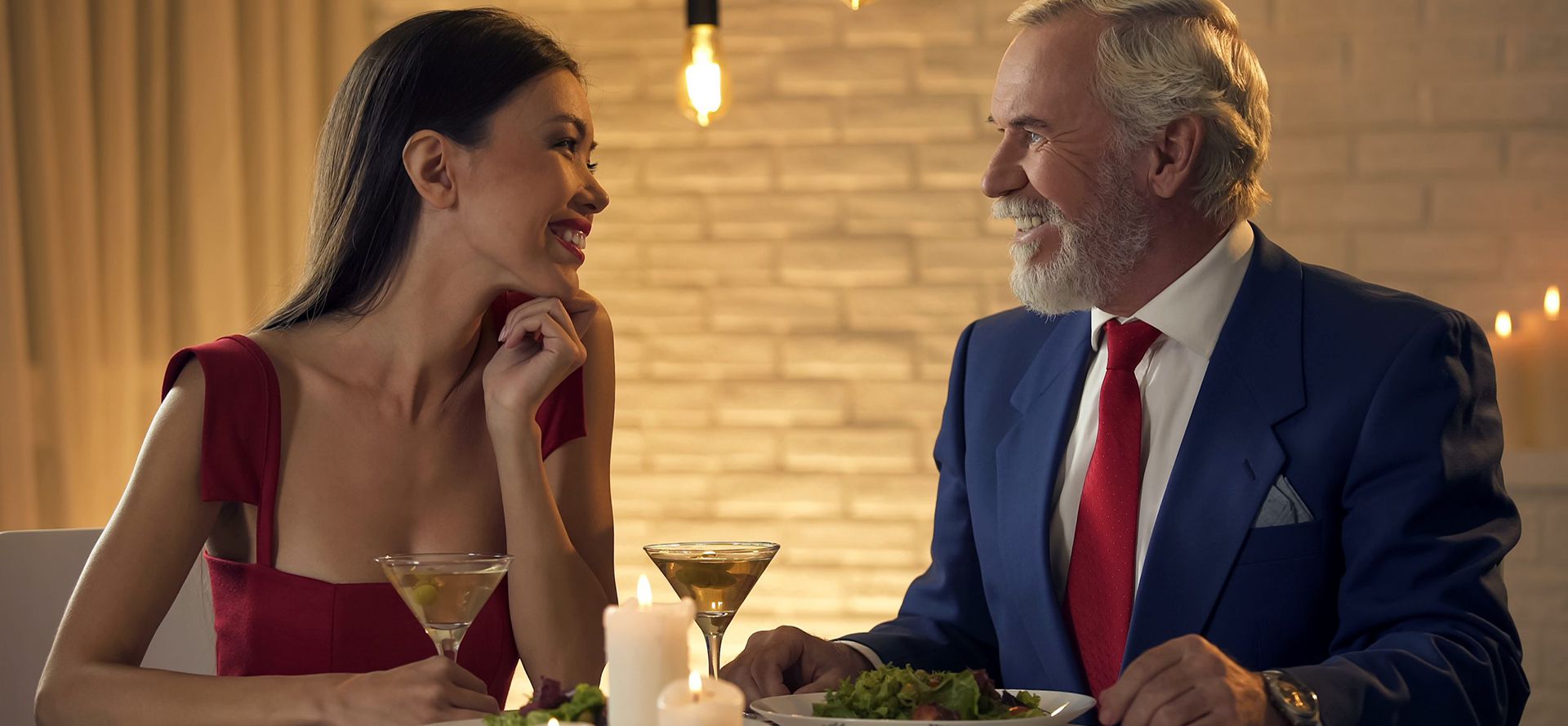 Young woman have a dinner with an older man.